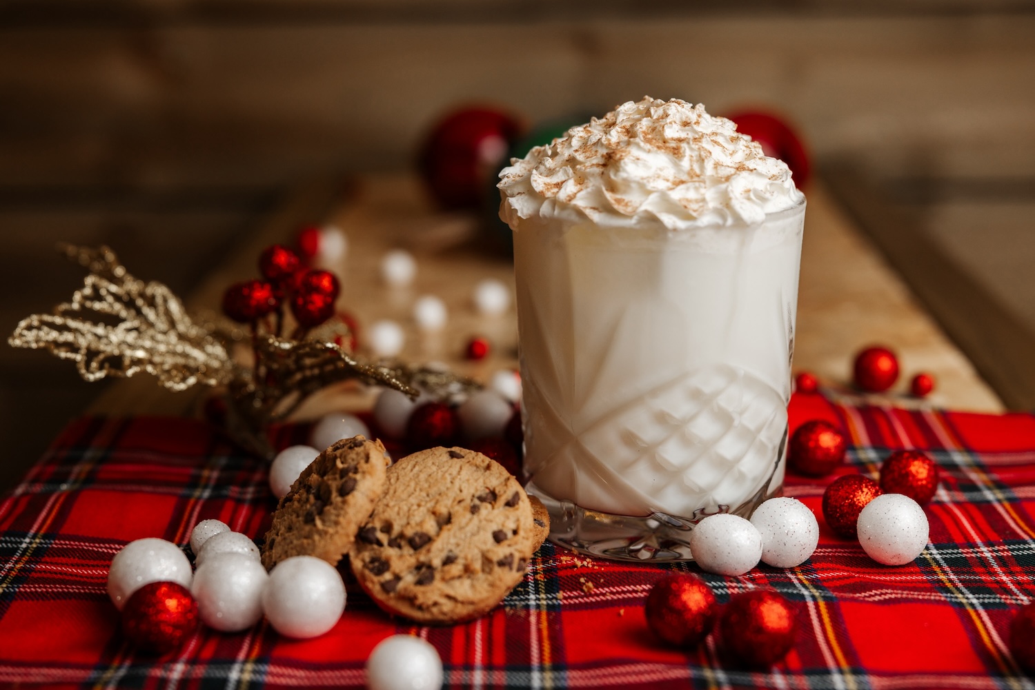 Whipped-cream topped festive drink on a tartan cloth