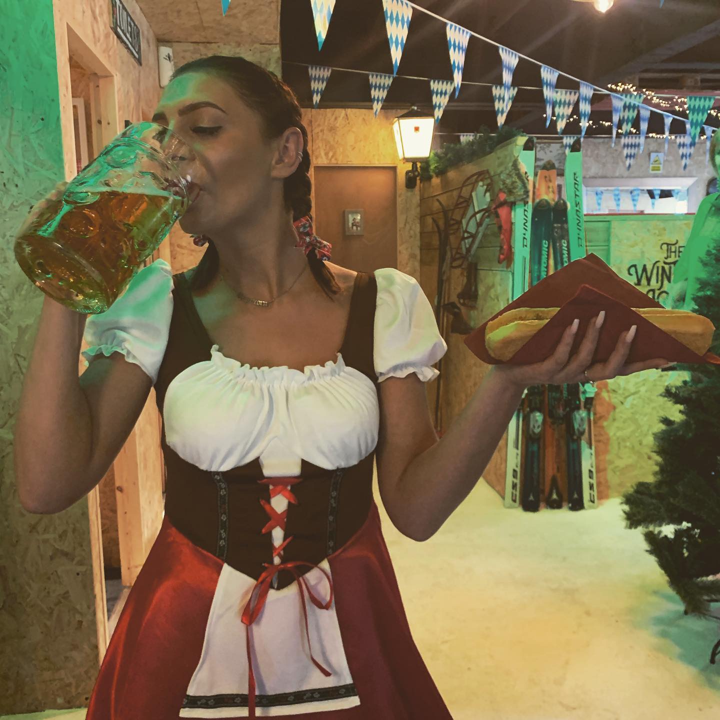 Bar staff in alpine dress with a litre stein